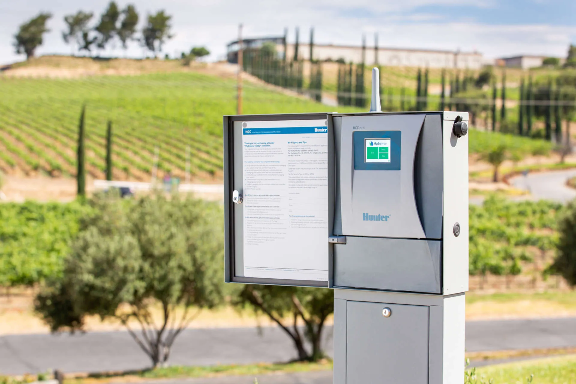 midland-irrigation-hcc-controller-hunter-vineyard-agriculture-L251020 Hunter HCC irrigation controller mounted outdoors with touchscreen display, managing commercial vineyard sprinkler zones for agricultural irrigation automation.